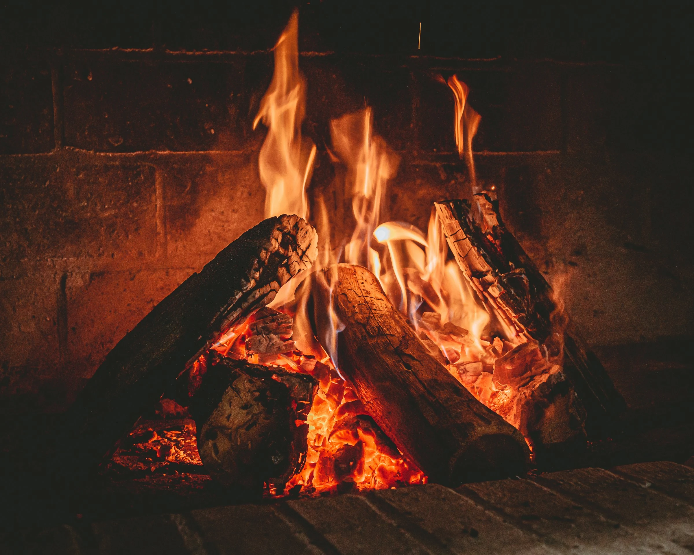 Burning wood inside a brick-lined firebox